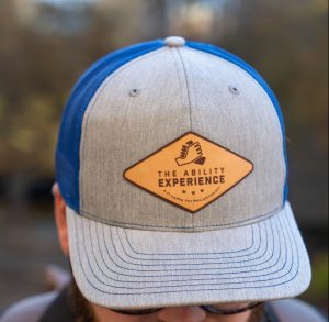 The Ability Experience hat with a man who has a beard.
